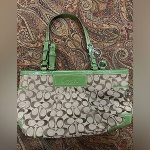 Brown and Green Coach purse that’s been worn twice.